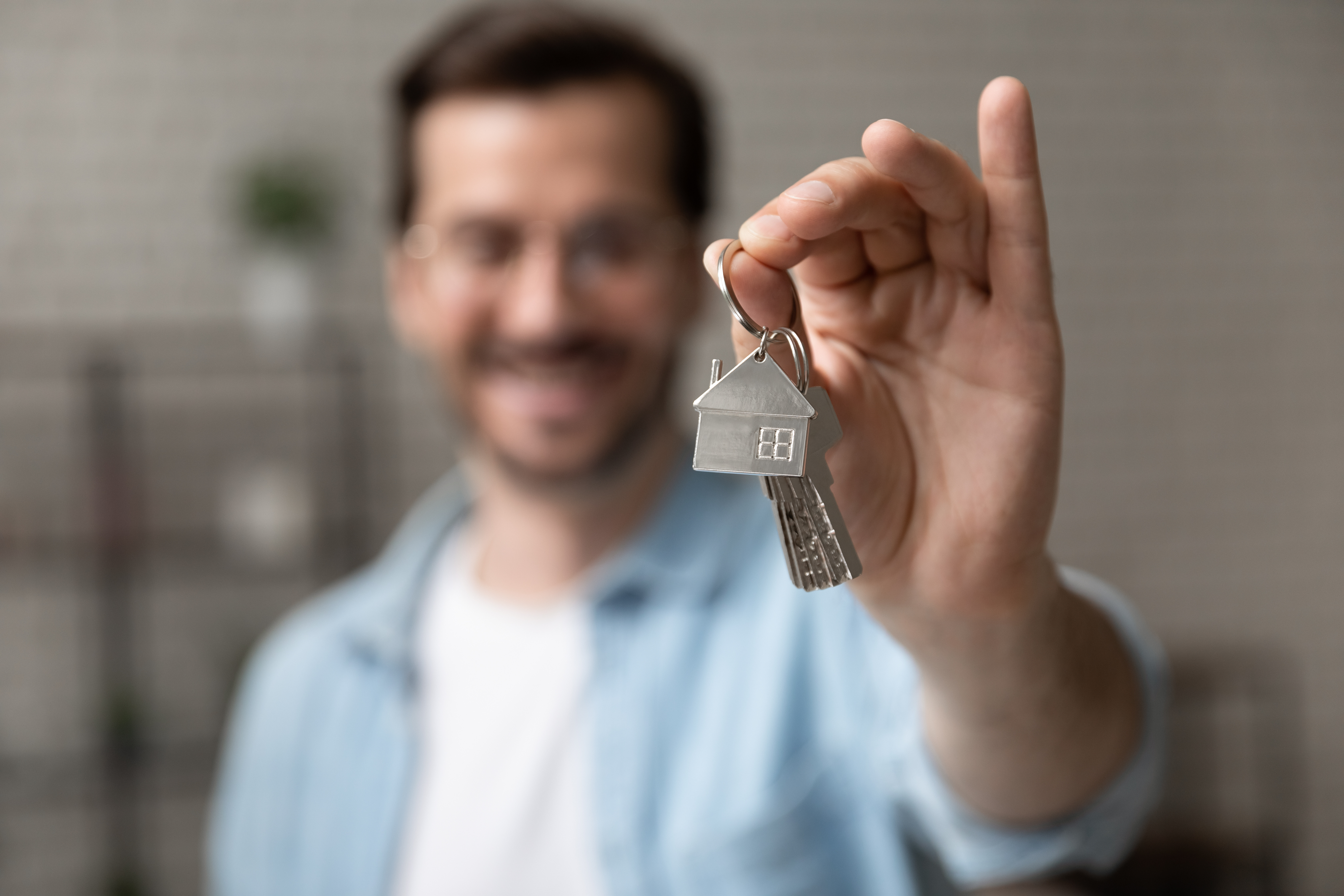 Man holding keys to a new home